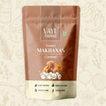 Vayu Farms Caramel Makhana 45g pouch on a doodle background