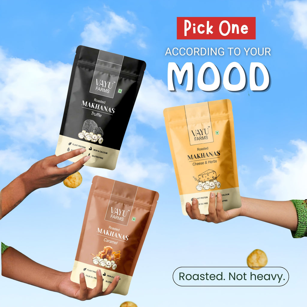 Vayu Farms Roasted Makhana pouches held up against a blue sky with text Pick One According To Your Mood, Roasted, Not heavy