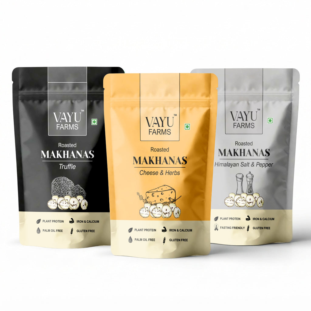 Three stand-up pouches of Vayu Farms Roasted Makhanas — Truffle, Cheese & Herbs and Himalayan Salt & Pepper — on a white background.