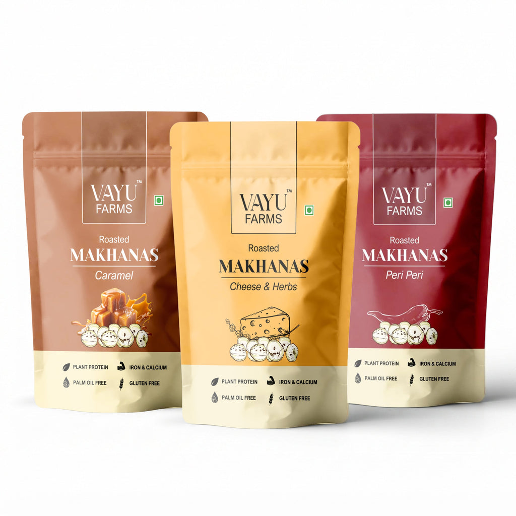 Three stand-up pouches of Vayu Farms Roasted Makhana in Caramel, Cheese & Herbs, and Peri Peri on a white background