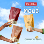 Vayu Farms Roasted Makhana pouches held up against a blue sky with text Pick One According To Your Mood, Roasted, Not heavy