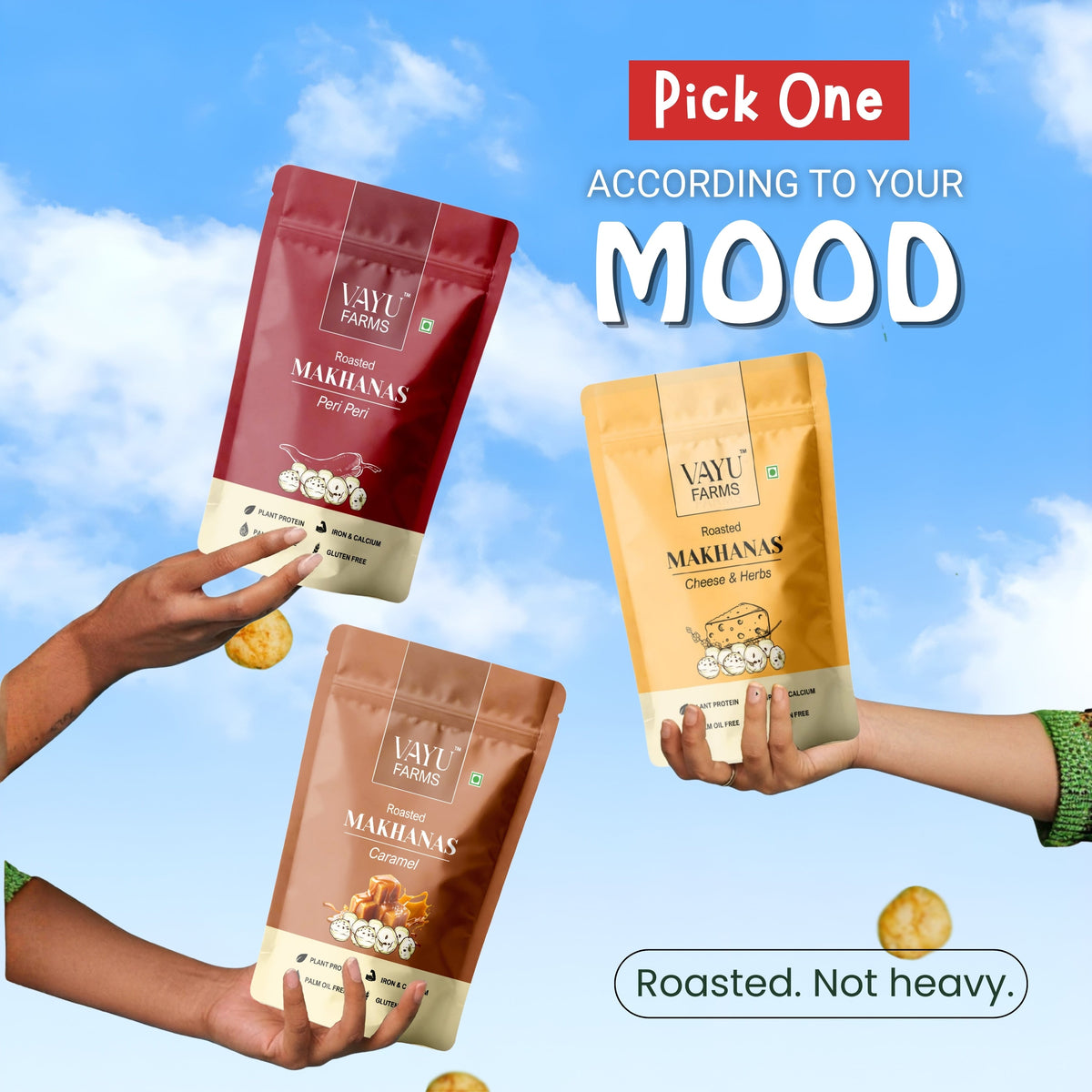 Vayu Farms Roasted Makhana pouches held up against a blue sky with text Pick One According To Your Mood, Roasted, Not heavy